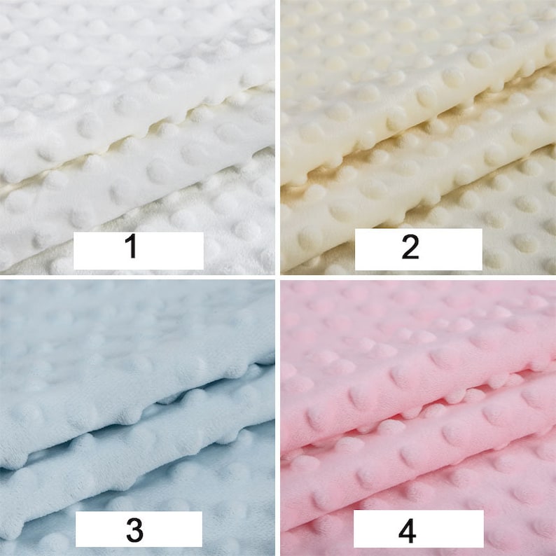 May include: Four fabric swatches with a textured, dotted pattern. The swatches are in four colours: white, cream, light blue, and pink. The swatches are numbered 1 through 4.