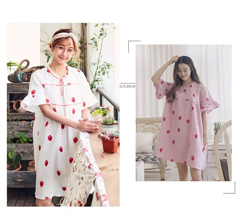 May include: Two women wearing short-sleeved dresses with strawberry patterns. The dress on the left is white with red strawberries, and the dress on the right is pink with red strawberries.