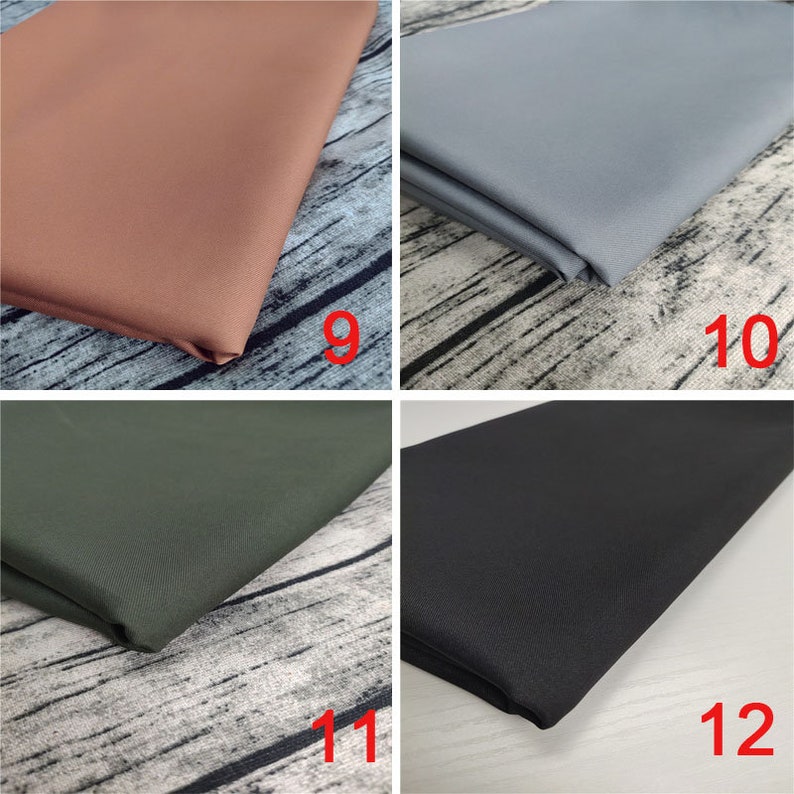 May include: Four fabric swatches in different colors: brown, gray, green, and black. The swatches are folded and laid out on a wooden surface.