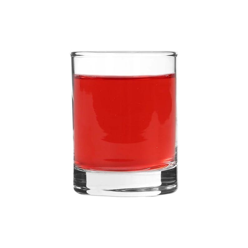 May include: A clear glass shot glass filled with a bright red liquid.