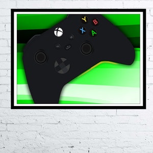 May include: A black video game controller with green and white stripes in the background. The controller has buttons labelled 'A', 'B', 'X', and 'Y'.