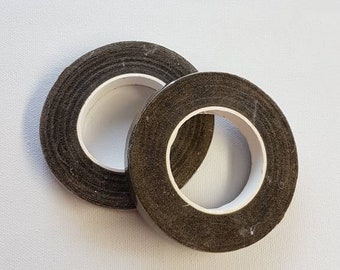 May include: Two rolls of brown floral tape, a craft supply used to secure stems and create bouquets.