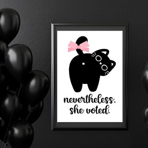 May include: A black and white illustration of a cat with a pink bow on its tail. The text "nevertheless. she voted." is below the cat.