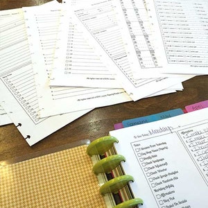 May include: A close-up of a green and gold planner with a checklist for the day. The checklist includes tasks such as "Check Instagram Picture" and "Check Email".