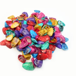 May include: A large pile of colorful, iridescent, and shiny seashells. The shells are in various shapes and sizes, and they are arranged in a random pattern.