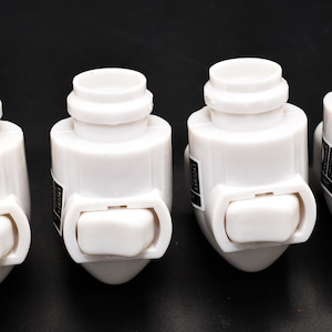 May include: Six white plastic light switch covers with a rocker switch. Each cover has a black label with text.