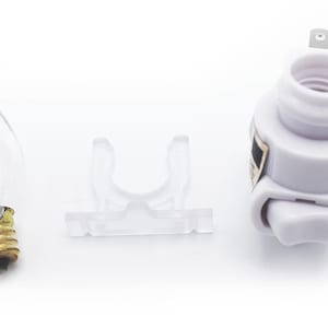 May include: A white plastic night light plug-in with a clear bulb and a clear plastic holder. The night light has a white on/off switch.