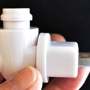 May include: White plastic electrical adapter with a 90-degree angle and a standard US plug.