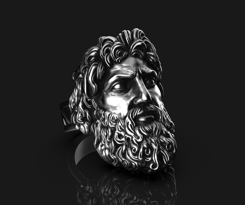 May include: A silver ring with a detailed sculpture of a man's face with a beard.