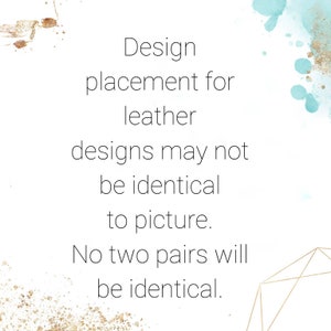 May include: Text overlay on a white background with a blue watercolor splatter and gold glitter. The text reads: "Design placement for leather designs may not be identical to picture. No two pairs will be identical."