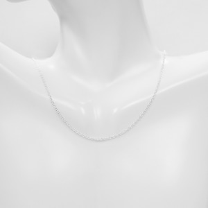 May include: A silver chain necklace on a white mannequin.