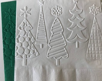 May include: White and green Christmas-themed paper napkins. The white napkins feature embossed Christmas trees and snowflakes. The green napkin has an embossed Christmas tree design. These napkins are perfect for holiday gatherings.