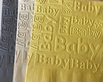 May include: Three square paper napkins in dark grey, cream, and yellow, each featuring an embossed pattern of the word Baby repeated in various orientations and sizes, along with small pacifier icons, all with a textured border at the bottom edge.