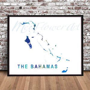 May include: A watercolor map of The Bahamas in shades of blue, green, and white. The map is framed in a black frame and is on a wooden floor.