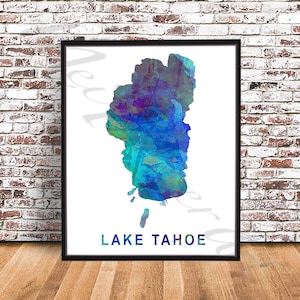May include: A watercolor painting of Lake Tahoe, a large lake in the Sierra Nevada mountains. The painting is in shades of blue, green, and purple. The text "LAKE TAHOE" is printed below the painting.