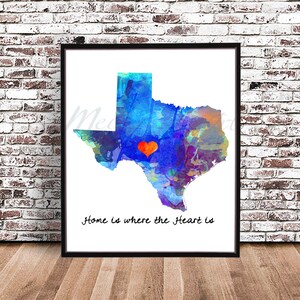 May include: A watercolor painting of the state of Texas in shades of blue, green, and purple. A red heart is painted in the center of the state. The text "Home is where the heart is" is written below the state.