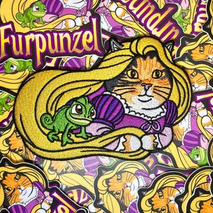May include: Embroidered patch featuring a cat with long blonde hair, a purple dress, and a green chameleon. The patch is labeled "Furpunzel" in gold lettering. The design is surrounded by similar patches.