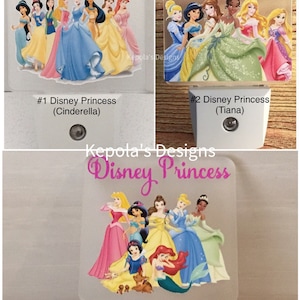 May include: Night lights featuring Disney Princesses. The top of each light has the words "Disney Princess" in pink script. The lights feature Cinderella, Tiana, and Belle. Each light has a different group of princesses.