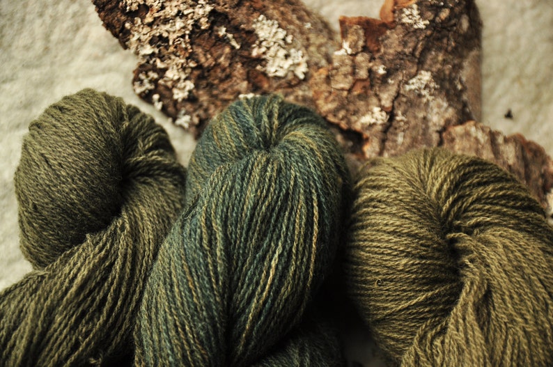 May include: Three skeins of yarn in shades of green and brown. The yarn is soft and fluffy, and it would be perfect for knitting or crocheting.