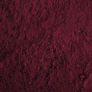 May include: Close-up of a deep red powder, possibly cocoa powder or beetroot powder, with a fine, grainy texture.