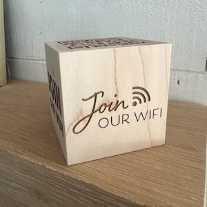 May include: A wooden block with the text "Join Our WiFi" and a wifi symbol carved into it.