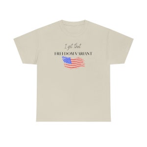May include: A beige t-shirt with the text "I got that FREEDOM VARIANT" and a distressed American flag graphic.