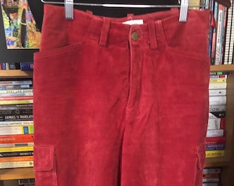 May include: Red suede pants with two front pockets and a button fly.