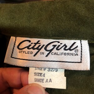 May include: A white tag with black text that reads "City Girl Styled in California" and a smaller white tag with black text that reads "Style # 3279 Size 4 Shade AA".
