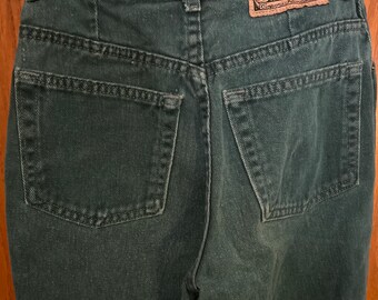 May include: A pair of dark green denim jeans with a back pocket and a label that reads "Express No. 14 Custom Exp Jeans Company from America".