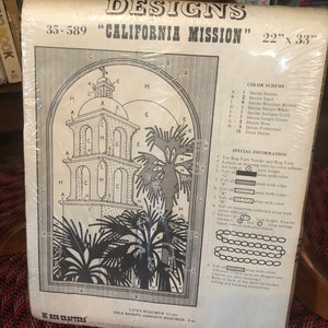 May include: A black and white rug hooking pattern for a California Mission design. The pattern includes a detailed drawing of a mission building with palm trees and a color key with 15 different colors. The pattern is labeled "35-589 "California Mission" 22" x 33"