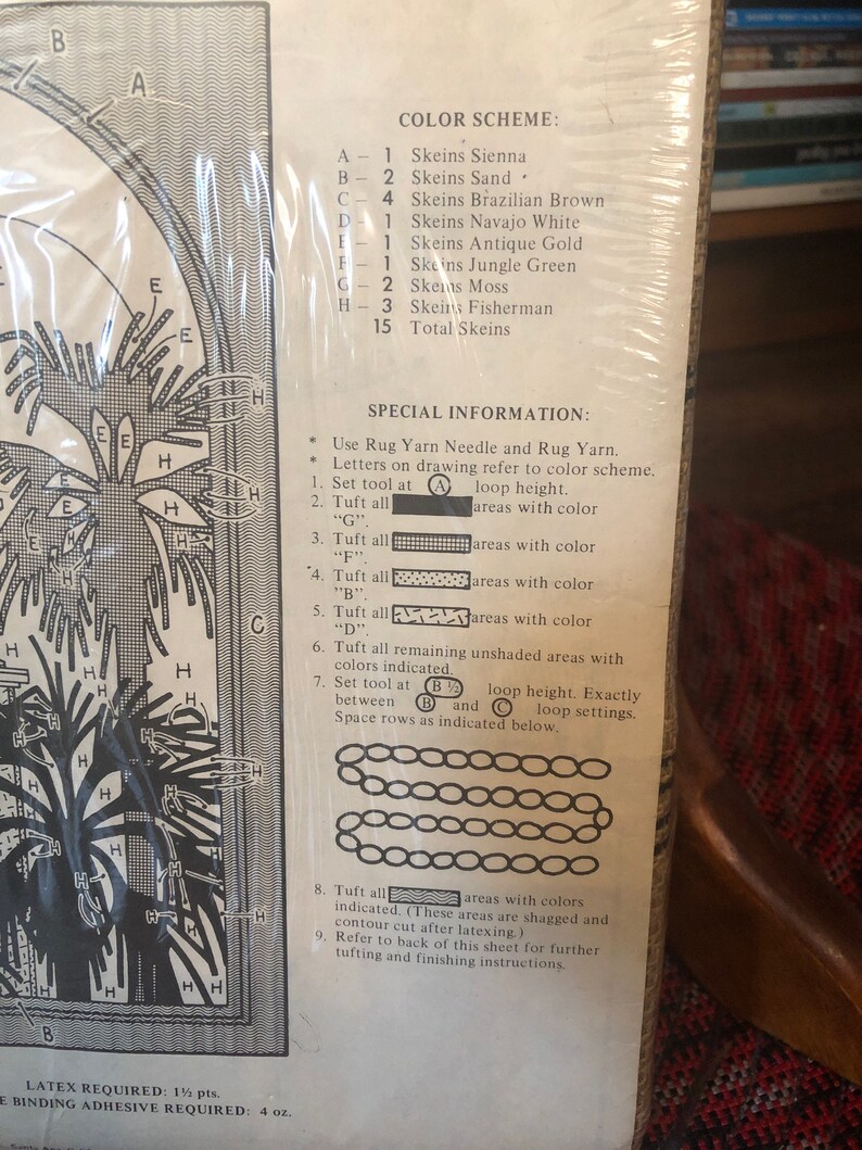 May include: A rug hooking pattern with a color scheme and instructions. The pattern includes a variety of colors, including sienna, sand, brown, white, gold, green, moss, and fisherman. The instructions include a list of materials, a color chart, and a step-by-step guide to hooking the rug.