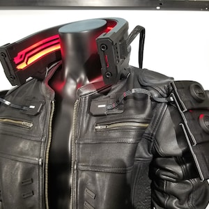 May include: A black leather jacket with a red light-up collar and black accents. The jacket has a zipper closure and multiple pockets.