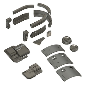 May include: A set of 3D printed model pieces for a sci-fi themed building or structure. The pieces are made of gray plastic and have a variety of shapes and sizes.