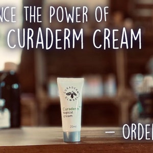 May include: A white tube of Curaderm topical cream, 20ml, is centered on a wooden surface. The image includes the text "EXPERIENCE THE POWER OF BEC5 CURADERM CREAM" and "ORDER TODAY". The background is blurred, suggesting a store setting.