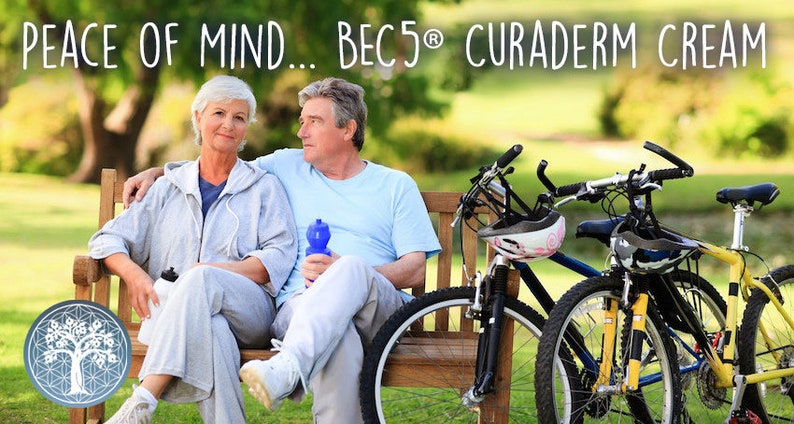 May include: An older couple sits on a park bench with bicycles nearby. The woman wears a gray sweatsuit, and the man wears a light blue shirt. The text "PEACE OF MIND... BEC5&reg; CURADERM CREAM" is at the top of the image.