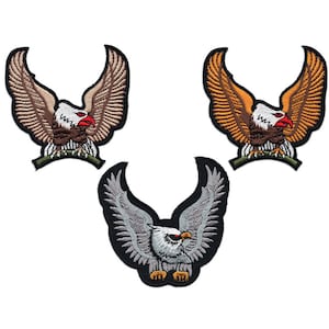 May include: Three embroidered iron-on patches of bald eagles with outstretched wings. The eagles are in brown, orange, and grey.