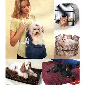 May include: A set of five pet beds and carriers. A woman carries a white dog in a blue carrier. A black and white striped carrier with a cat inside. A floral patterned bed with a white dog inside. A leopard print bed with a brown and white dog. A red and black plaid blanket with a black dog.