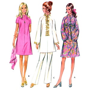 May include: A vintage sewing pattern featuring three different dress styles. The first dress is pink with short sleeves and a collar. The second dress is white with long sleeves and a collar. The third dress is floral with long sleeves and a collar. The pattern includes instructions for sizes A, B, and C.