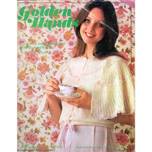 May include: A magazine cover for Golden Hands featuring a woman wearing a crocheted top and jacket. The cover text reads "To knit a lace-yoke jacket and an evening top".