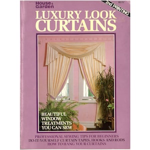 May include: A book titled "Luxury Look Curtains" with a pink cover and a photo of a window with white curtains and a valance. The book includes instructions for making beautiful window treatments and includes tips for beginners.