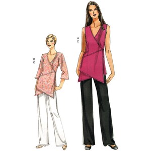 May include: Two women wearing different versions of a wrap top. The top on the left is a printed pink and white top with 3/4 sleeves. The top on the right is a solid pink sleeveless top. Both women are wearing trousers. The woman on the left is wearing white trousers and the woman on the right is wearing black trousers. The image includes the letters A, B, and C.