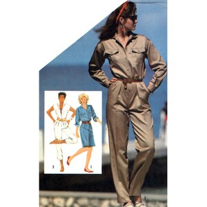 May include: A woman wearing a tan jumpsuit with a brown belt and a red headband. She is standing on a sidewalk with a blue sky and ocean in the background. The image also shows two women wearing jumpsuits, one in white and one in blue.