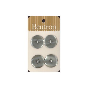 May include: A pack of four silver buttons with two holes each. The buttons are on a white card with the word "Beutron" printed in brown letters.