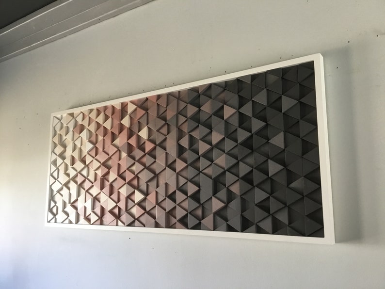 May include: A framed wall art piece made of wood triangles in shades of beige, brown, and black. The triangles are arranged in a geometric pattern, creating a gradient effect.