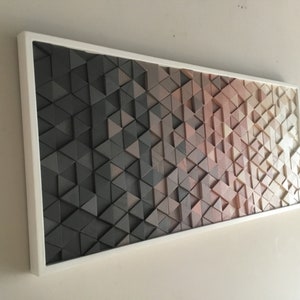 May include: A framed wall art piece made of wood triangles in shades of brown, gray, and beige. The triangles are arranged in a geometric pattern, creating a gradient effect.