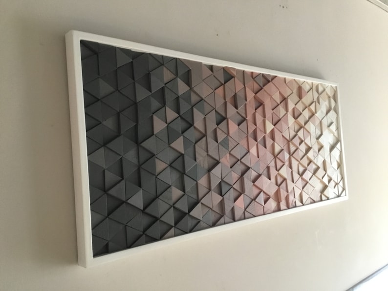 May include: A framed wall art piece made of wood triangles in shades of brown, gray, and beige. The triangles are arranged in a geometric pattern, creating a gradient effect.