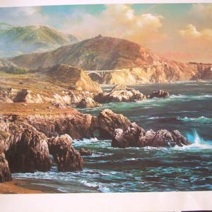May include: A painting of a coastal landscape with a bridge in the distance. The painting features a rocky coastline, blue water, and a cloudy sky. The painting is signed by the artist, "Alexander  De  Cora".