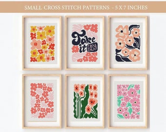May include: Six framed cross stitch patterns, each measuring 5x7 inches. The patterns feature floral designs in shades of pink, red, yellow, and green, as well as a pattern with the text "Take it easy" in a retro font.