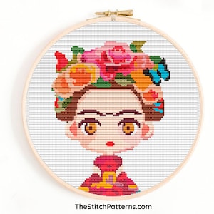 May include: Cross stitch pattern of a colorful cartoon Frida Kahlo with flowers in her hair and a red dress.