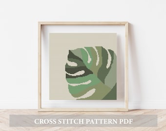 May include: A cross stitch pattern PDF featuring a green and white monstera leaf on a beige background.